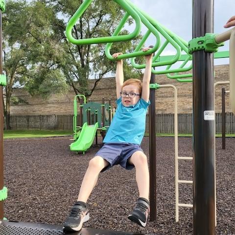 Child on monkey bars