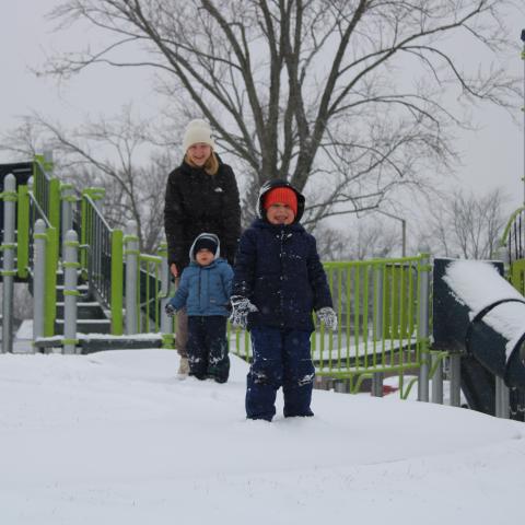 family in snow at Heritage Park 