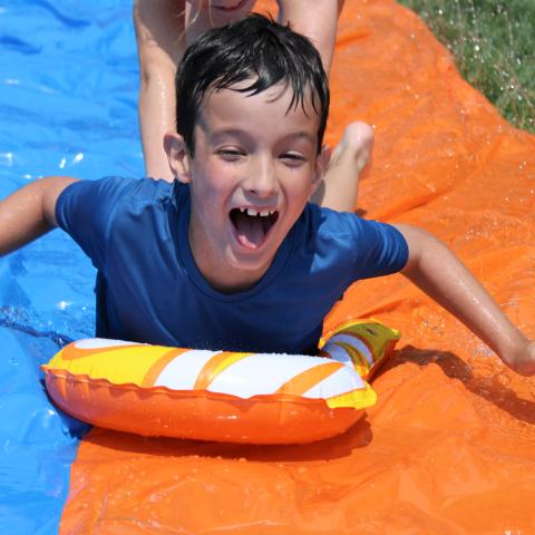 Child on slip and slide 