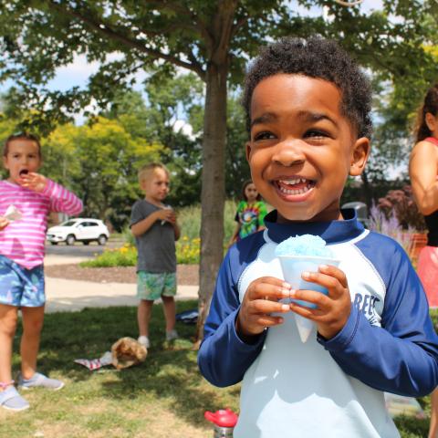 Child outside with snow cone 
