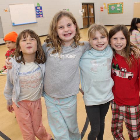 Four students in gym making funny faces 